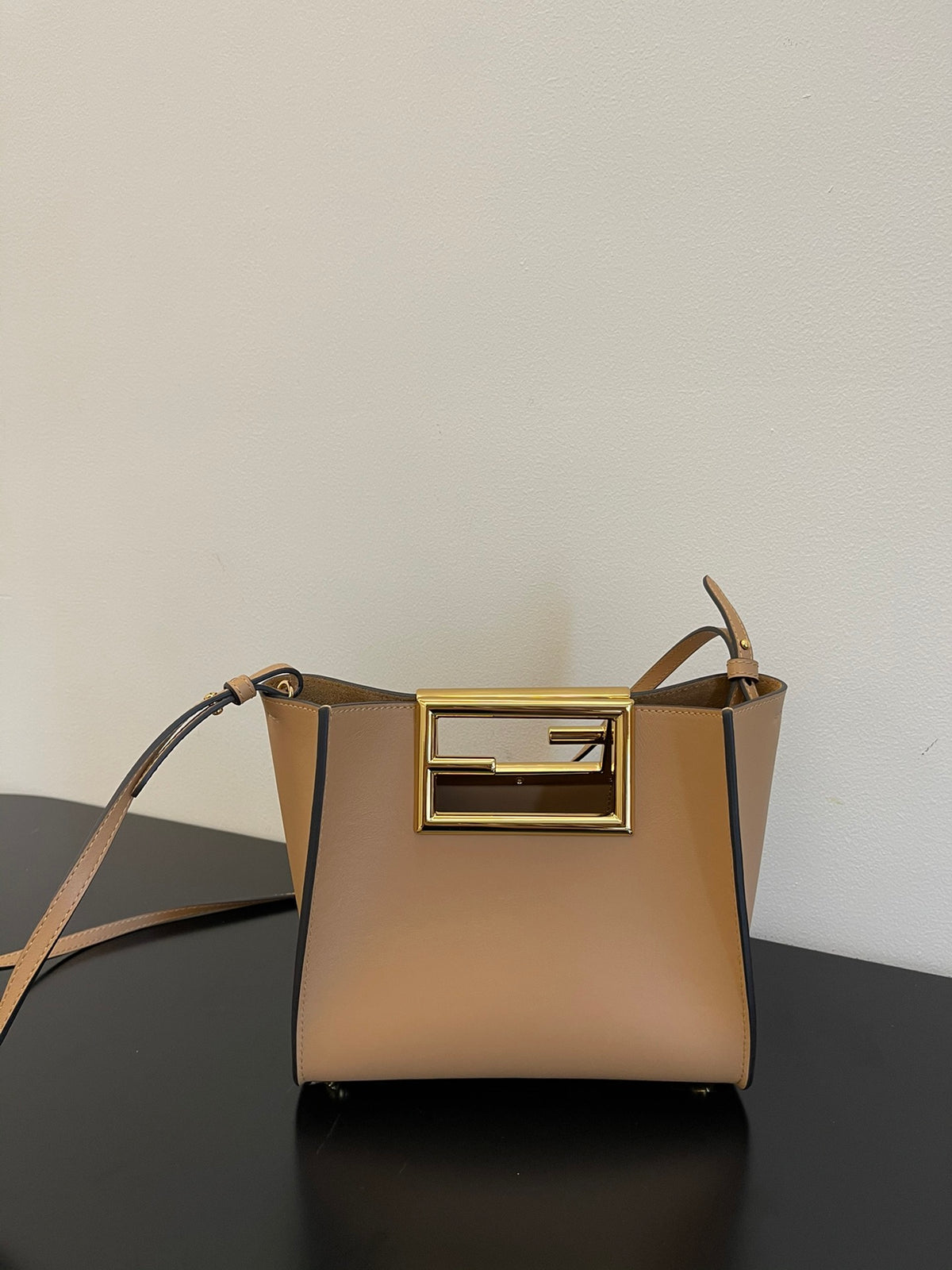 Tan Leather Bucket Bag with Gold Geometric Clasp and Shoulder Strap