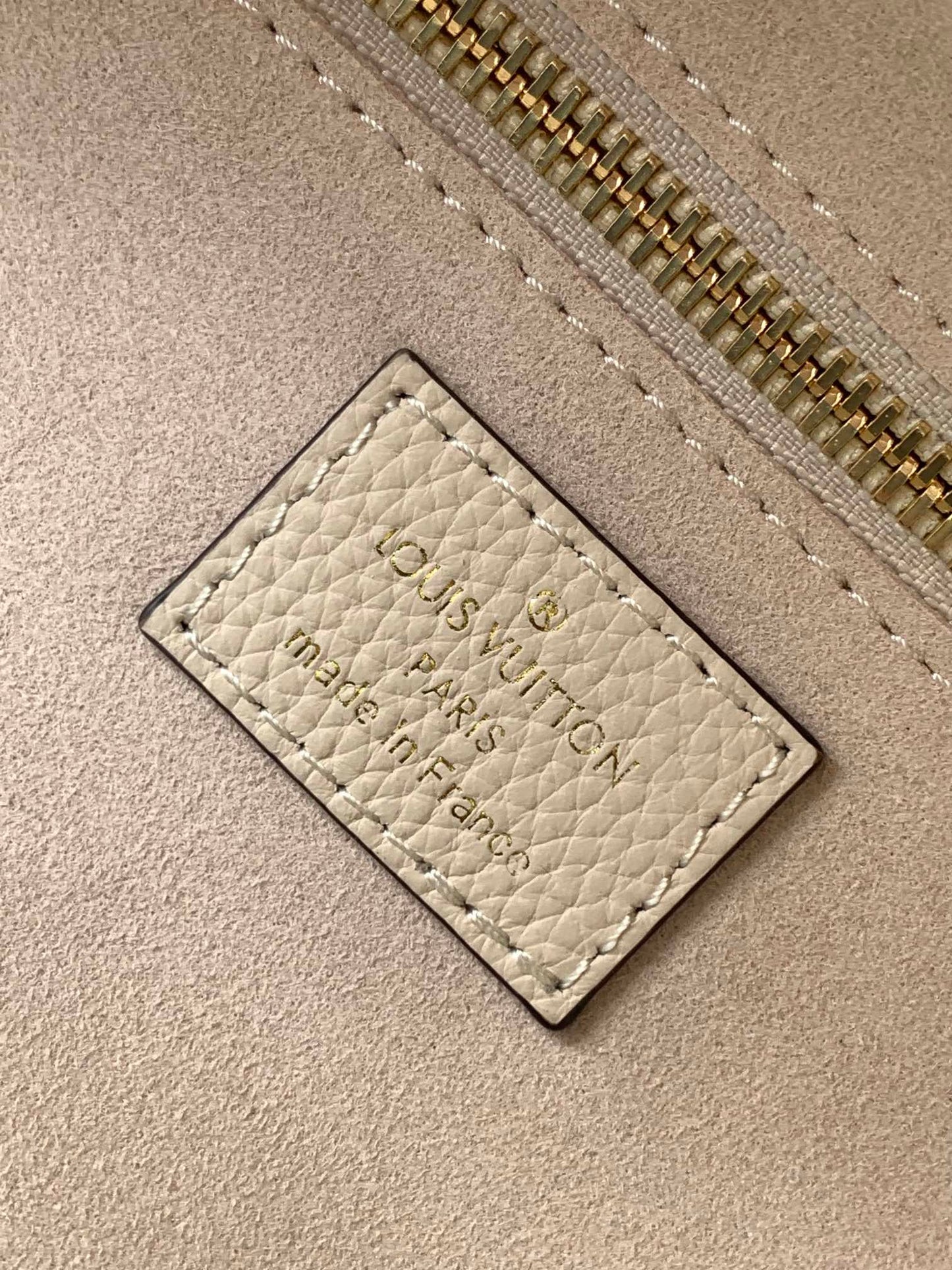 Louis Vuitton Elegant Beige Embossed Leather Tote Bag with Side Drawstrings