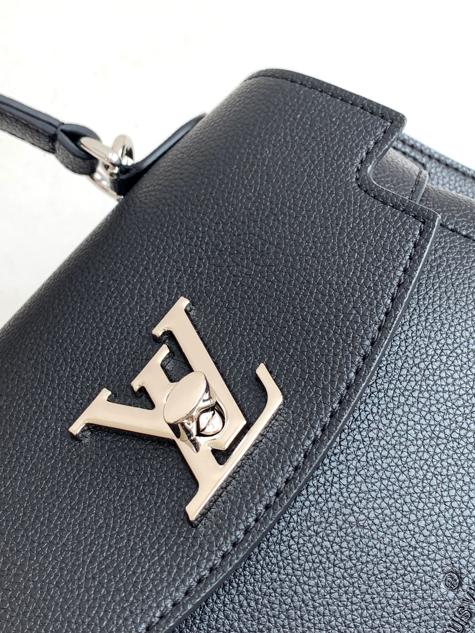 Louis Vuitton Elegant Black Leather Top Handle Handbag with Silver Metal Clasp