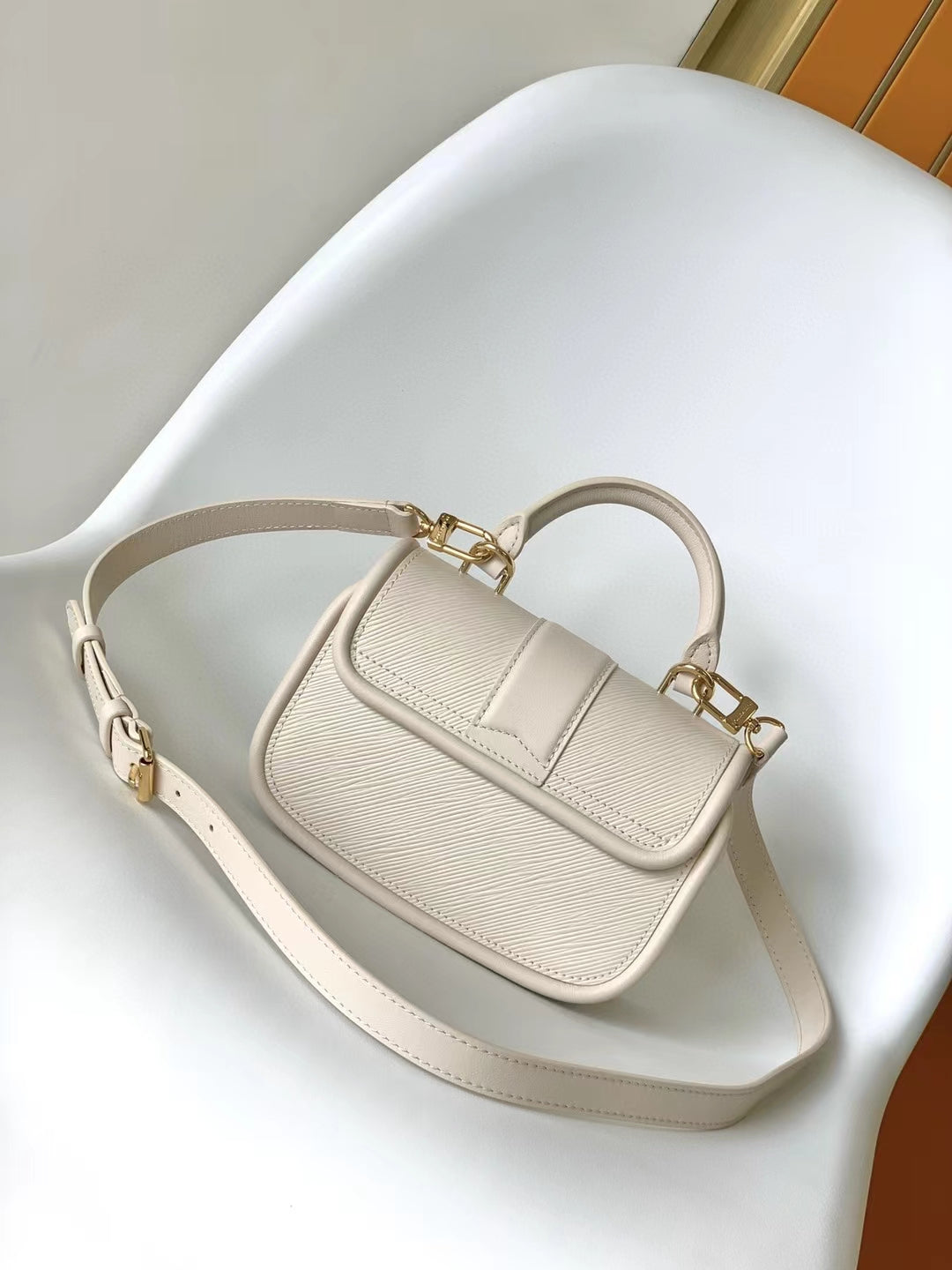 Louis Vuitton Elegant Beige Mini Top Handle Bag with Gold Lock Clasp