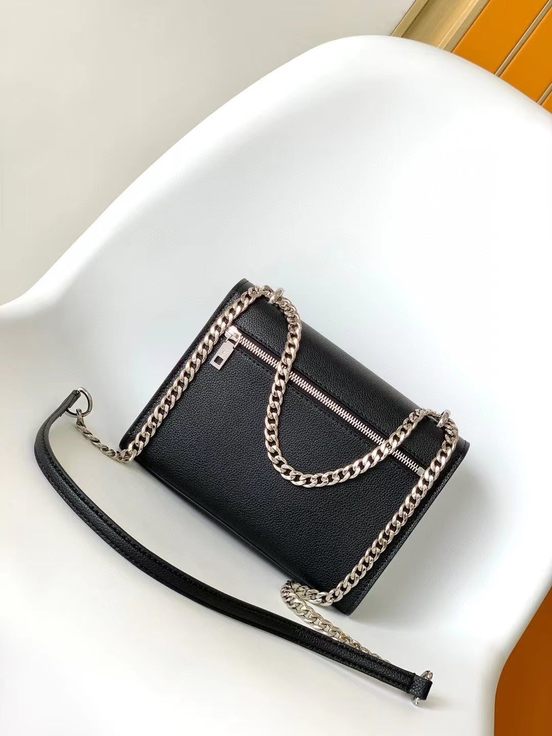 Louis Vuitton Elegant Black Leather Envelope Handbag with Silver Chain Strap