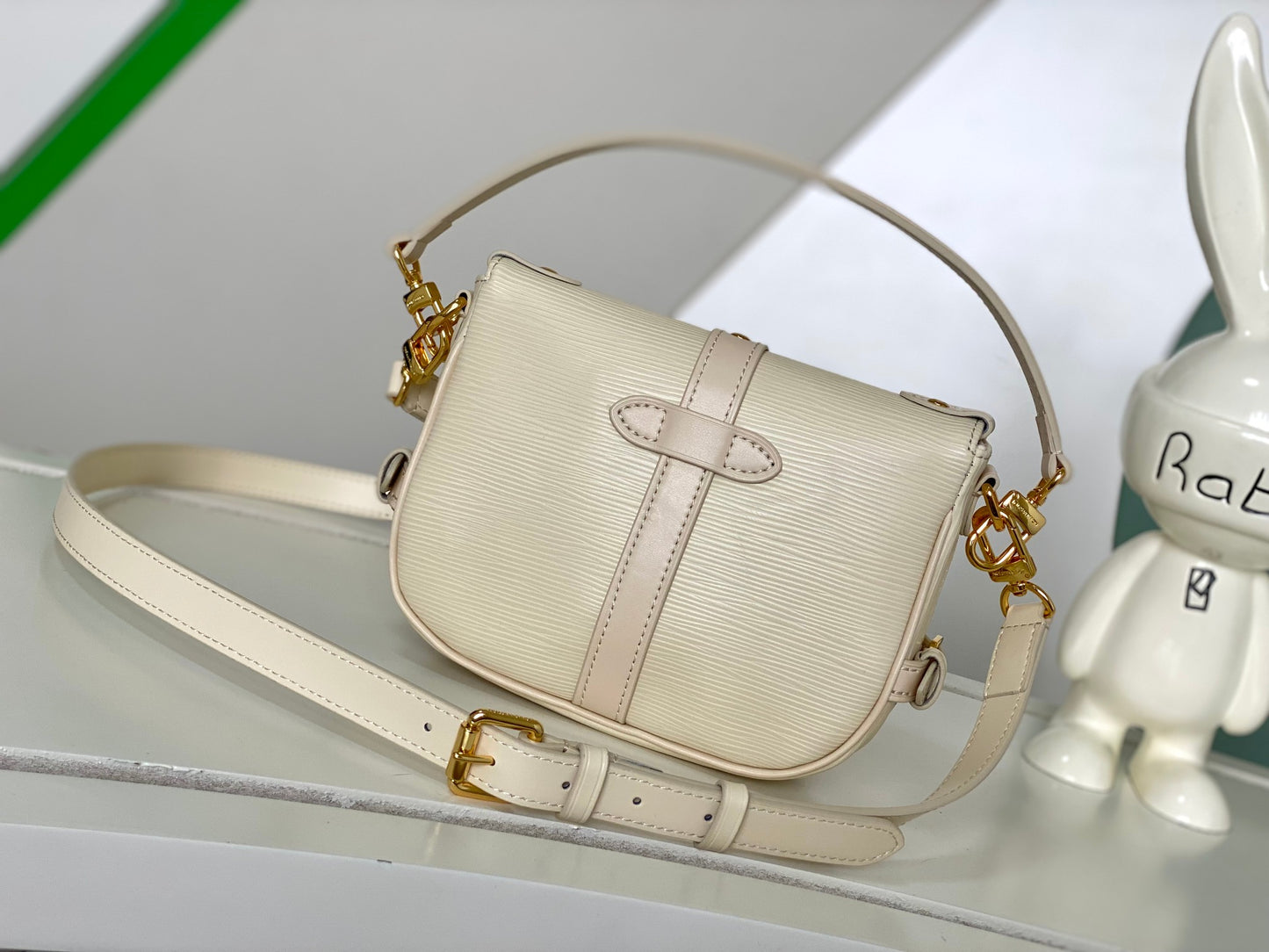 Louis Vuitton Elegant Pale Pink Leather Crossbody Saddle Bag with Gold Hardware