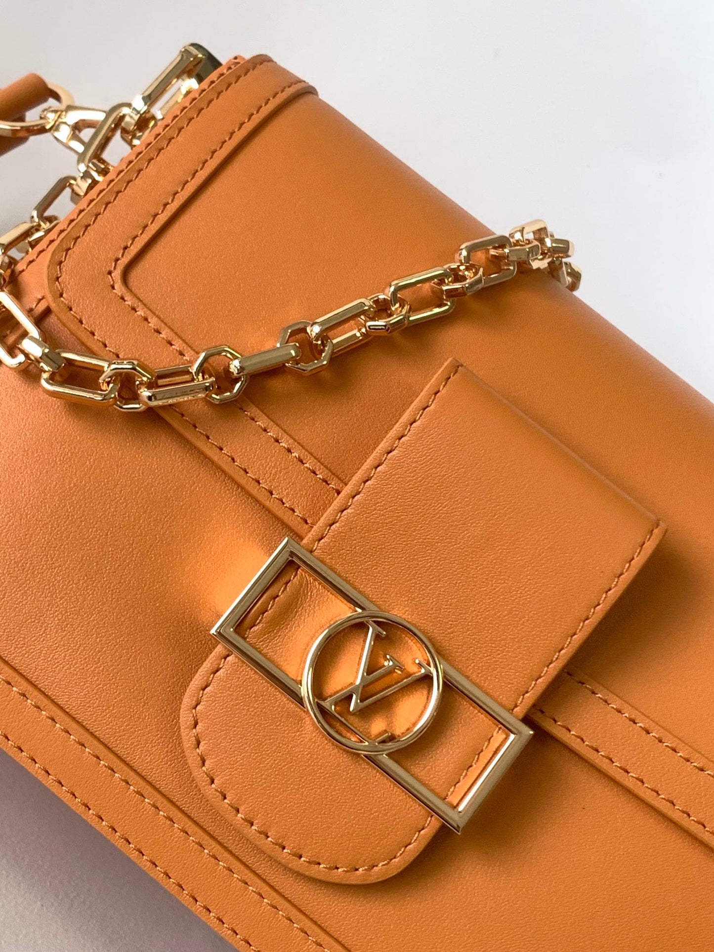 Women's Tan Leather Crossbody Handbag with Gold Chain Strap and Logo Buckle