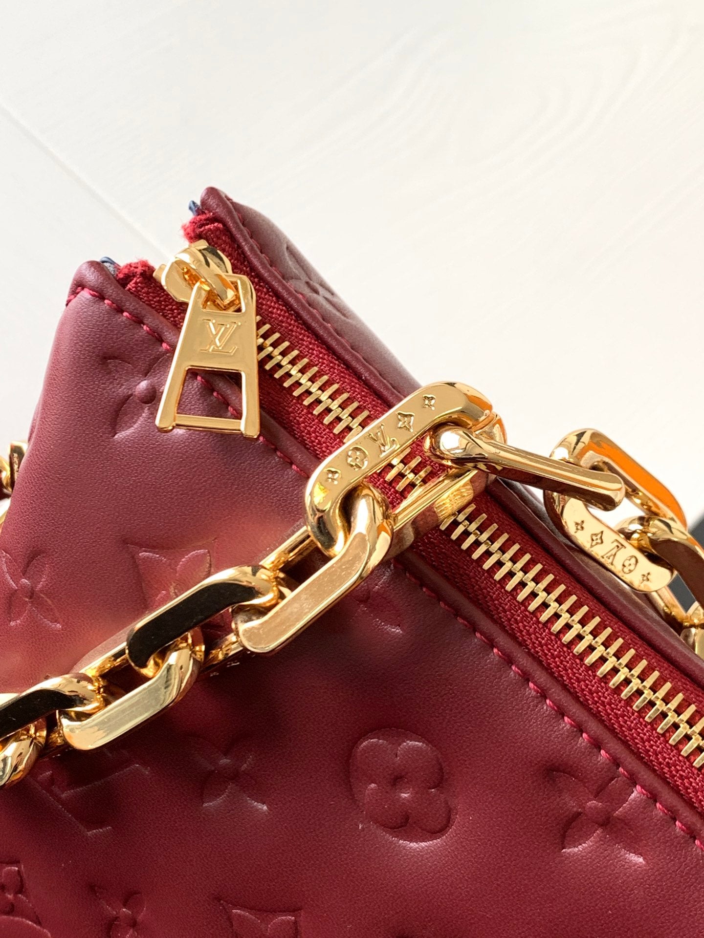Louis Vuitton Elegant Burgundy Embossed Crossbody Bag with Wide Fabric Strap