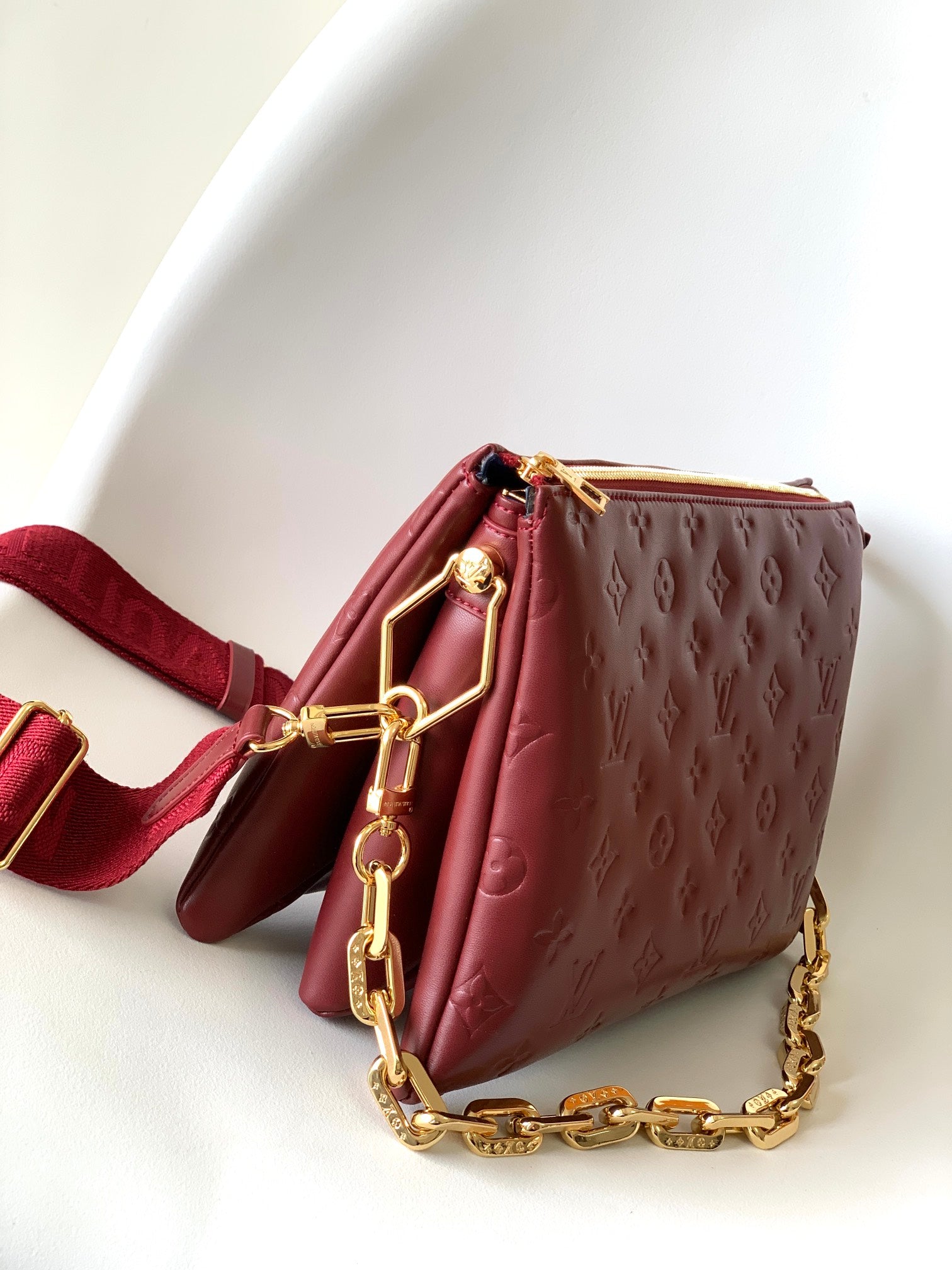 Louis Vuitton Elegant Burgundy Embossed Crossbody Bag with Wide Fabric Strap