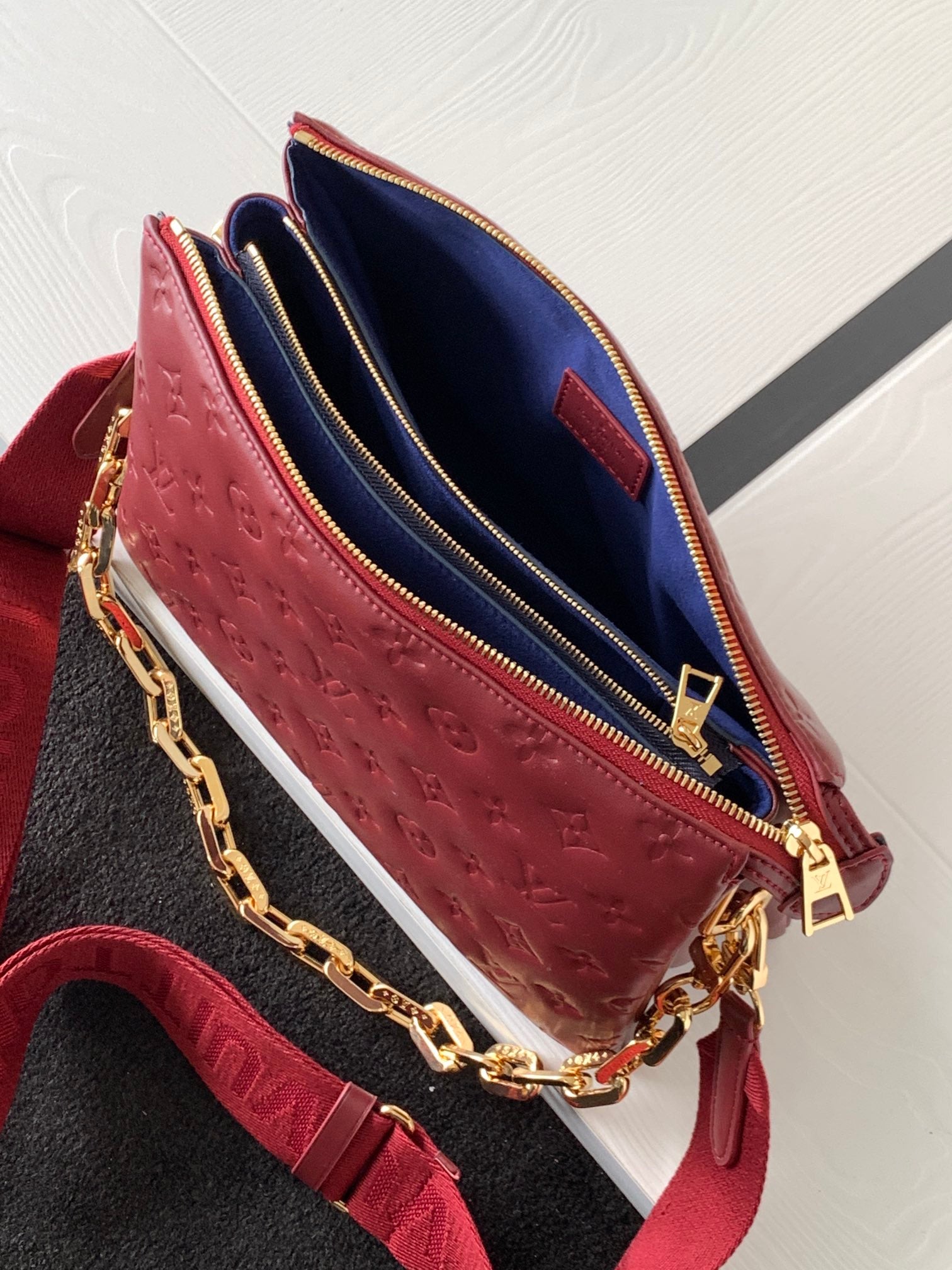 Louis Vuitton Elegant Burgundy Embossed Crossbody Bag with Wide Fabric Strap