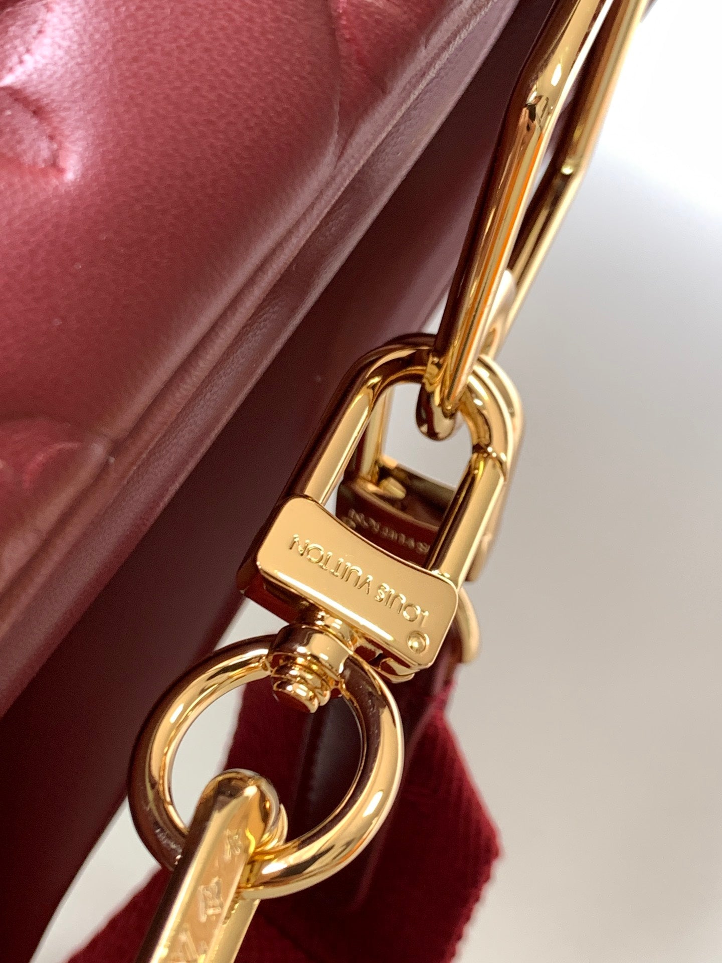Louis Vuitton Elegant Burgundy Embossed Crossbody Bag with Wide Fabric Strap