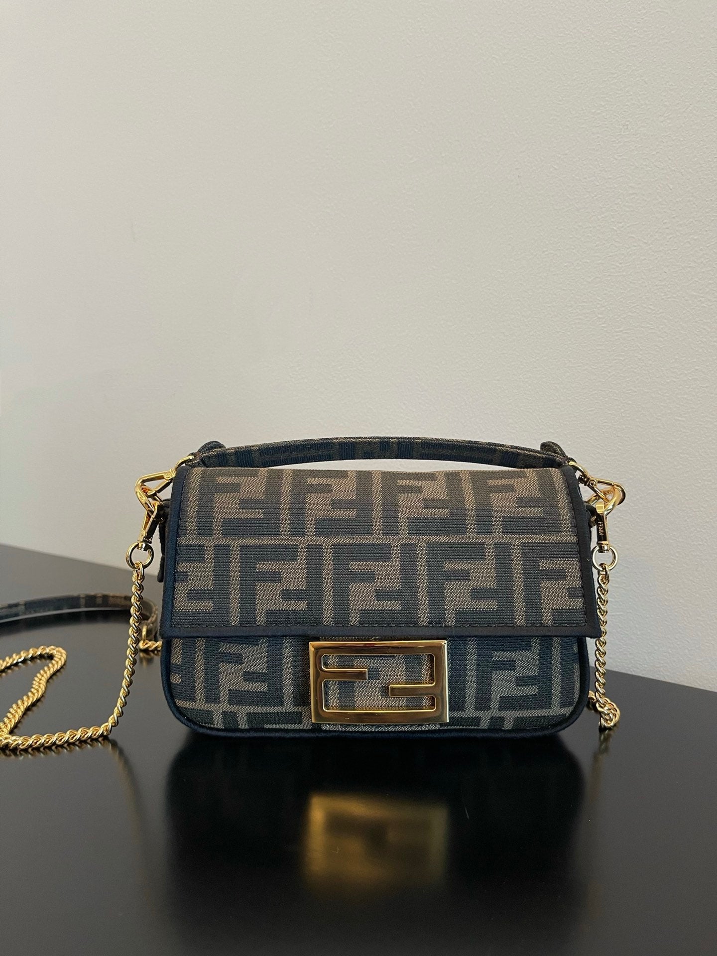 Fendi Mini Baguette Bag in Iconic FF Logo Canvas with Gold-Tone Hardware