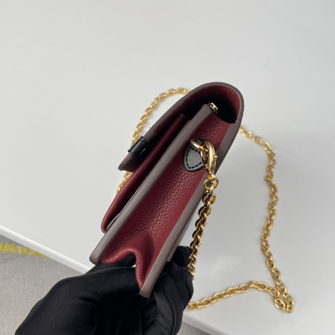 Louis Vuitton Brown Checkered Crossbody Bag with Gold Chain and Red Accent