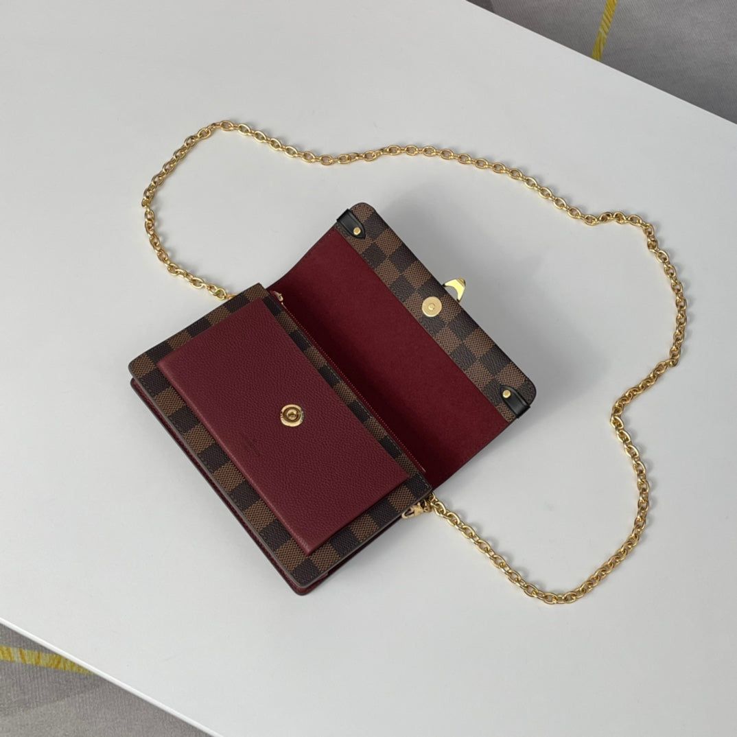 Louis Vuitton Brown Checkered Crossbody Bag with Gold Chain and Red Accent