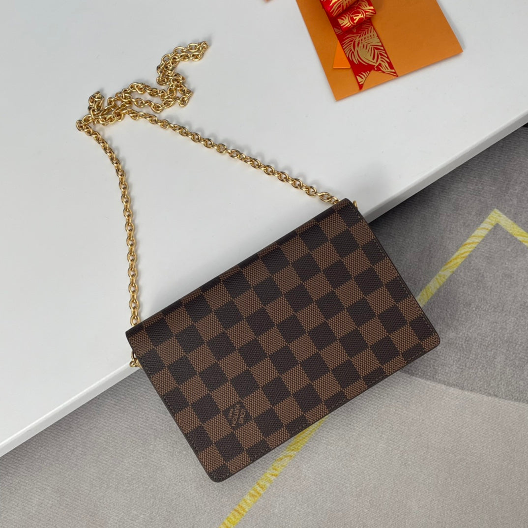 Louis Vuitton Brown Checkered Crossbody Bag with Gold Chain and Red Accent