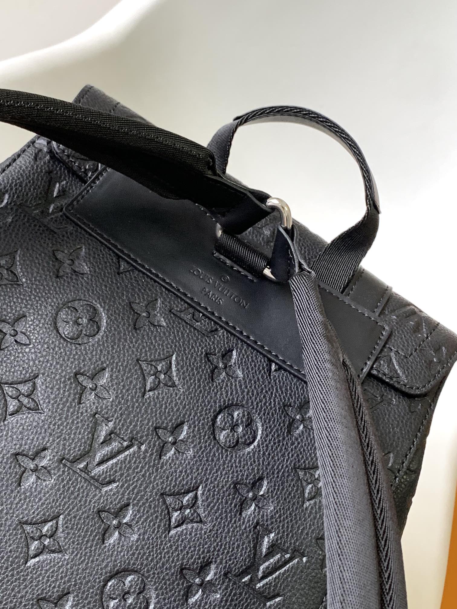 Louis Vuitton Luxury Black Embossed Leather Backpack with Side Pockets