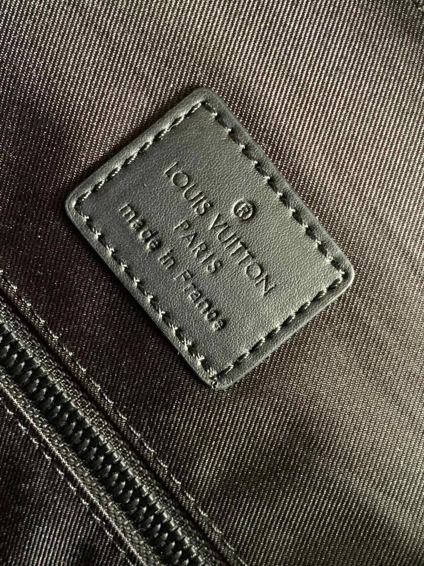 Louis Vuitton Luxury Black Embossed Leather Backpack with Side Pockets