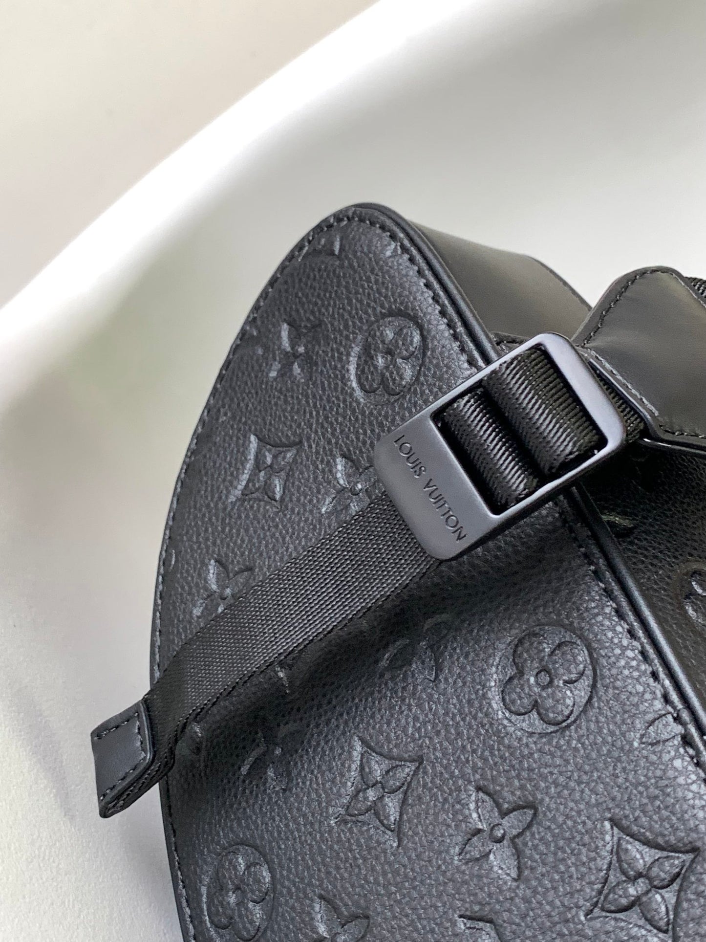Louis Vuitton Luxury Black Embossed Leather Backpack with Side Pockets