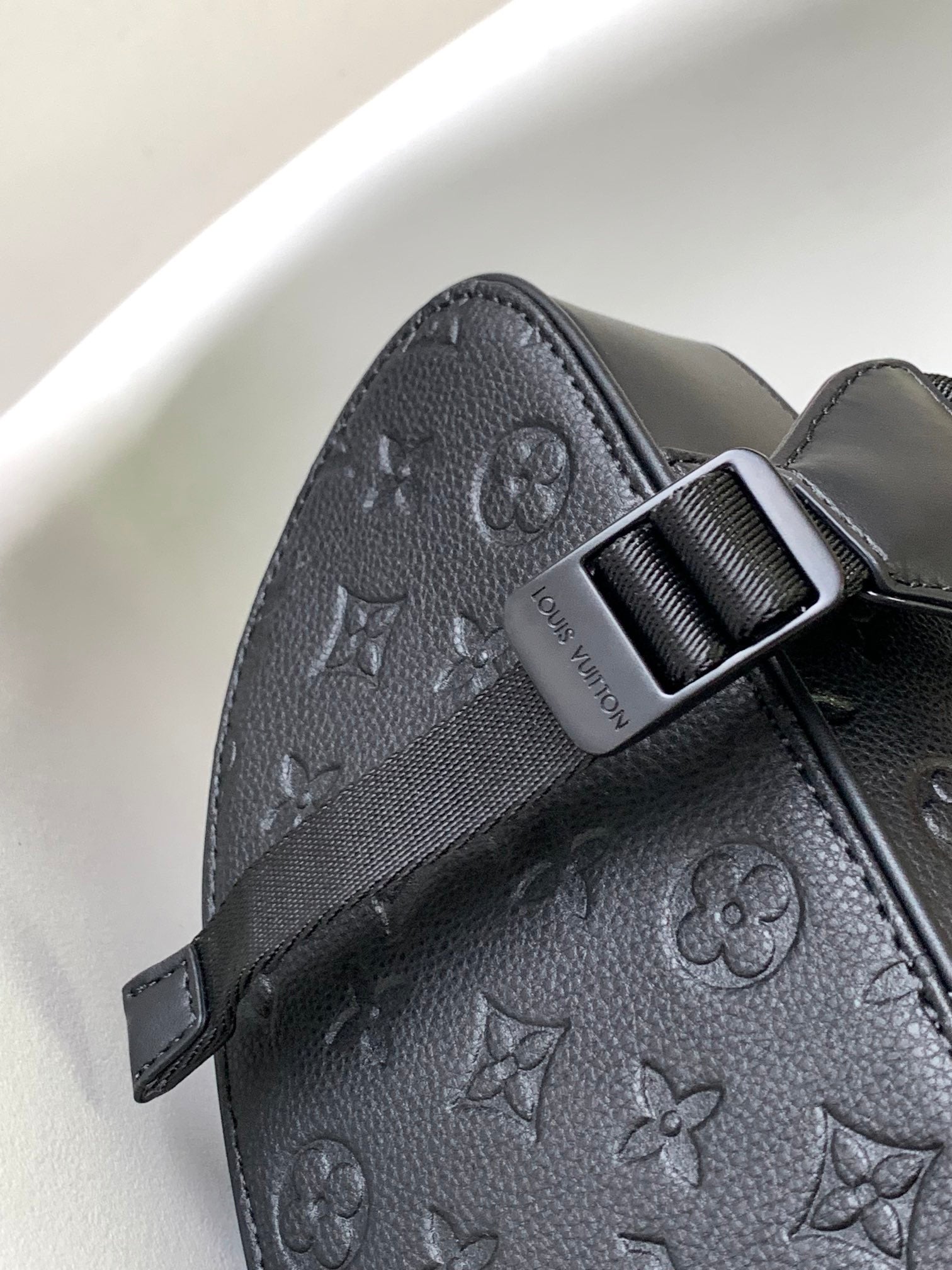Louis Vuitton Luxury Black Embossed Leather Backpack with Side Pockets