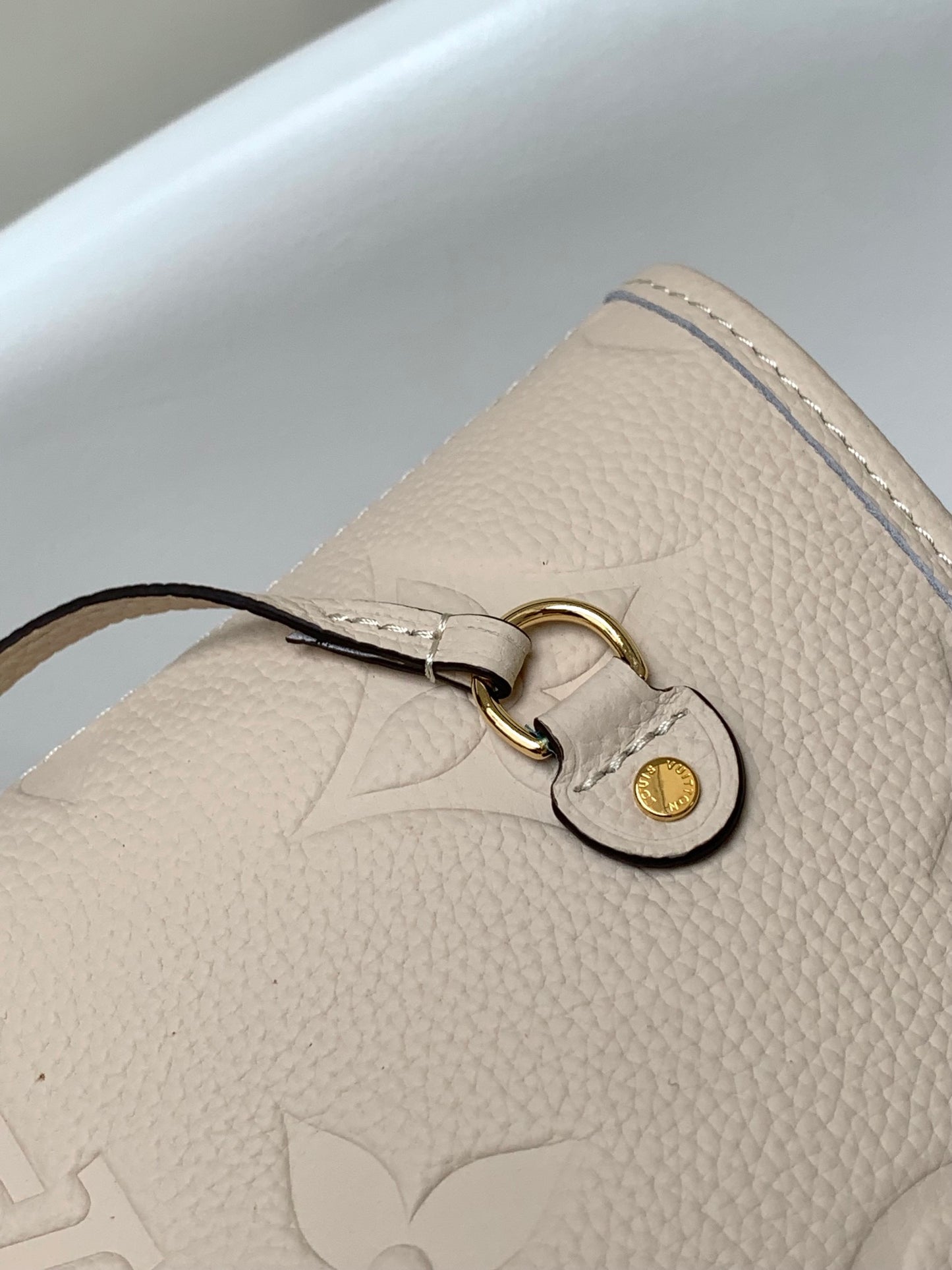 Louis Vuitton Elegant Beige Embossed Leather Tote Bag with Side Drawstrings