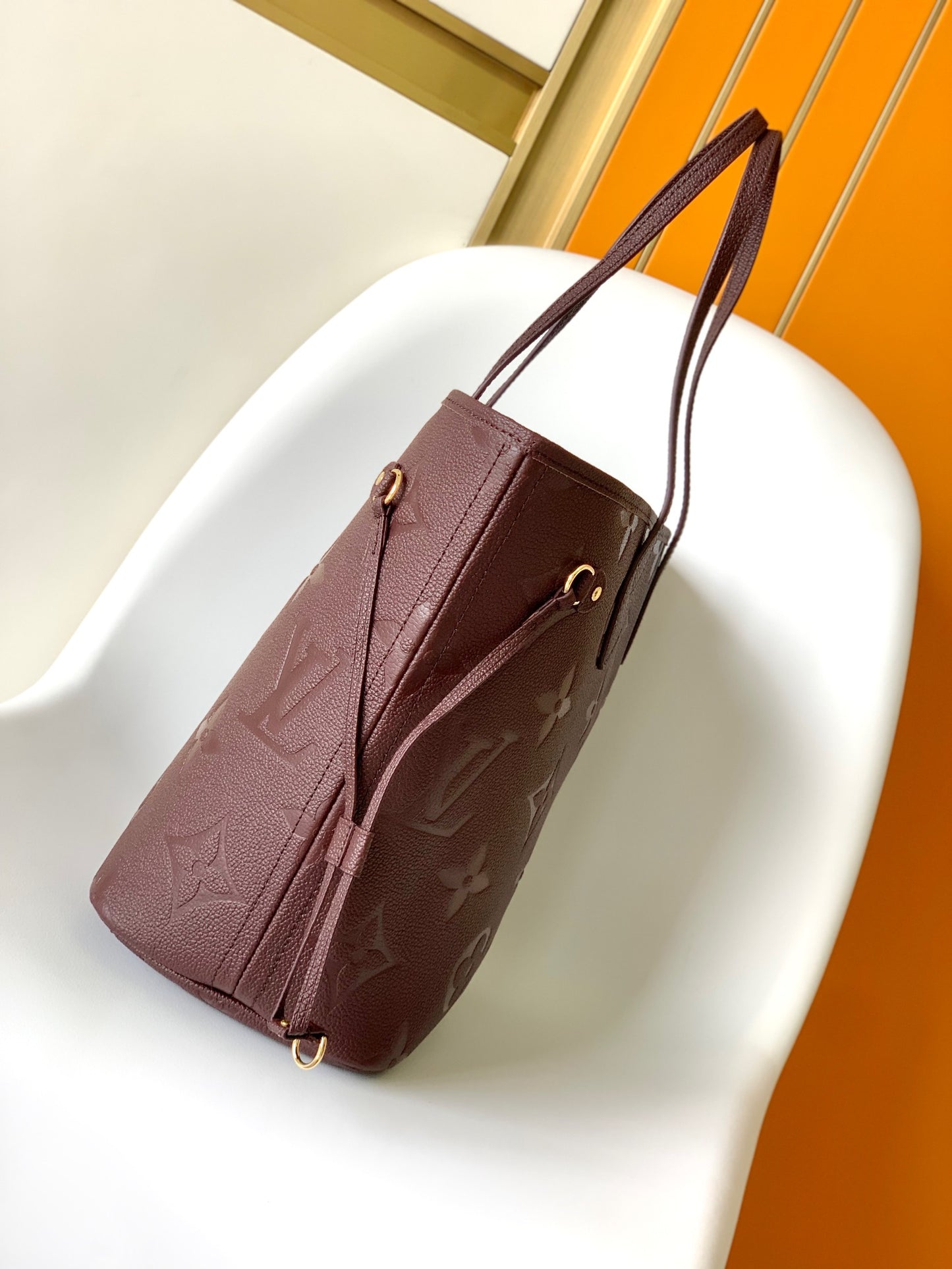Louis Vuitton Elegant Burgundy Embossed Leather Tote Bag with Side Drawstrings
