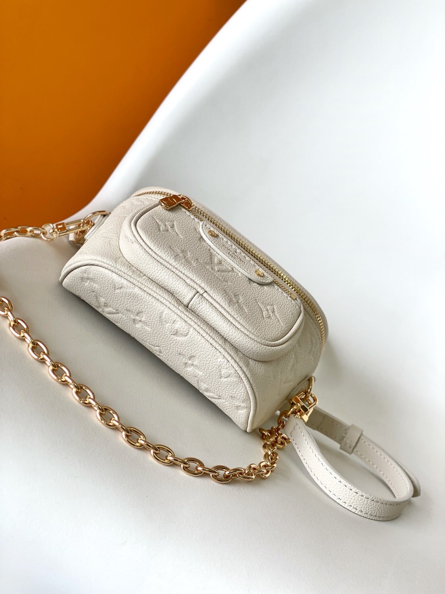 Louis Vuitton Elegant Cream Embossed Leather Crossbody Bag with Gold Chain