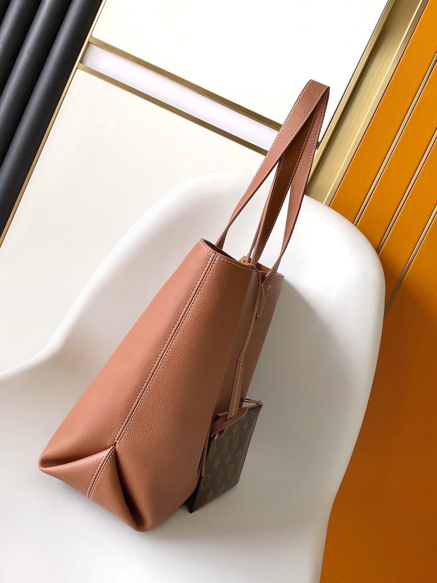 Louis Vuitton Classic Brown Leather Tote Bag with Gold Lock Accent and Shoulder Straps