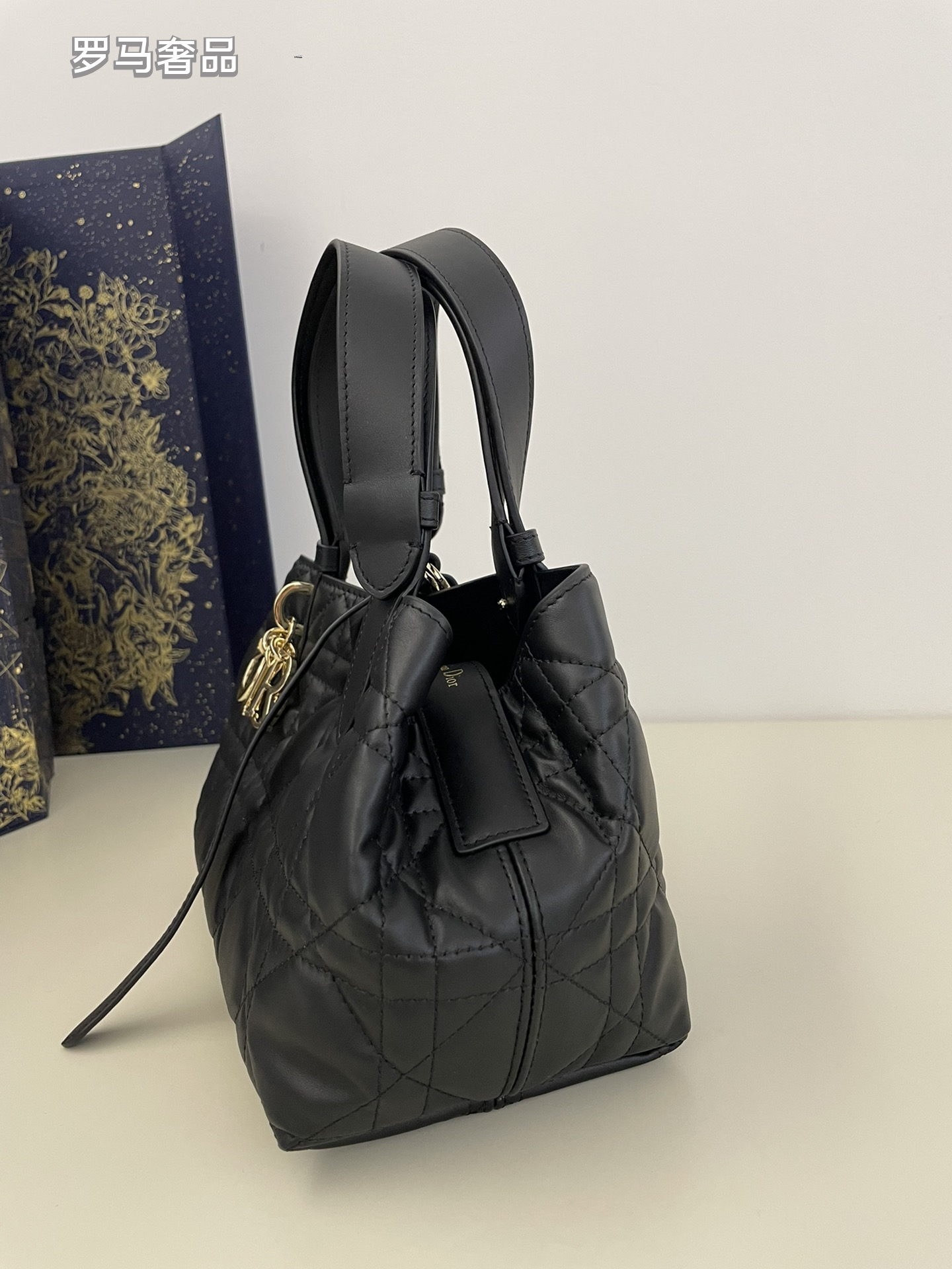 Dior Elegant Black Quilted Top Handle Handbag with Gold Letter Charms